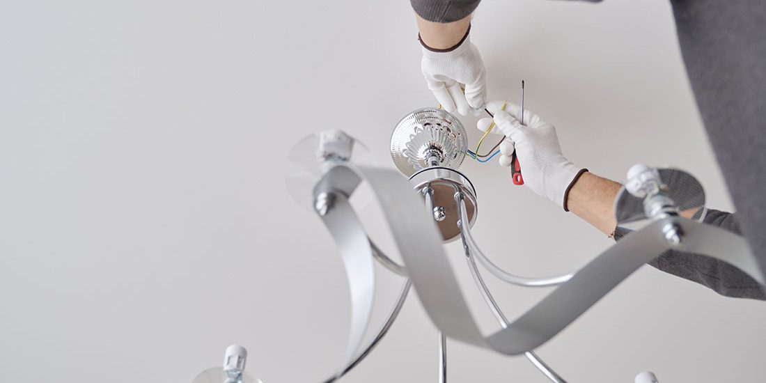 Installation ceiling lamp, hands of electrician fixing chandelier Bodrum'da Avize Montaj Hizmetleri